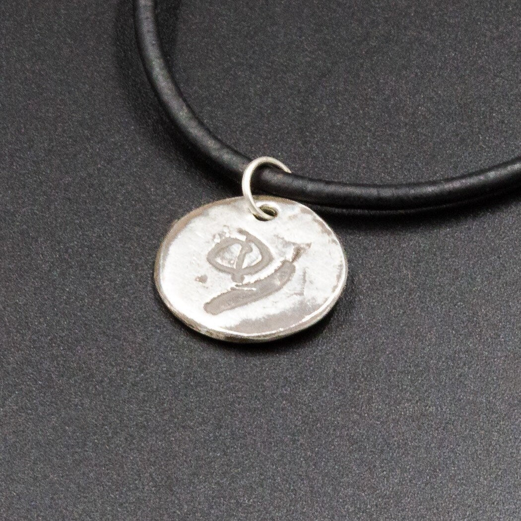 A pure silver pendant stamped with the initial or name of your choice.