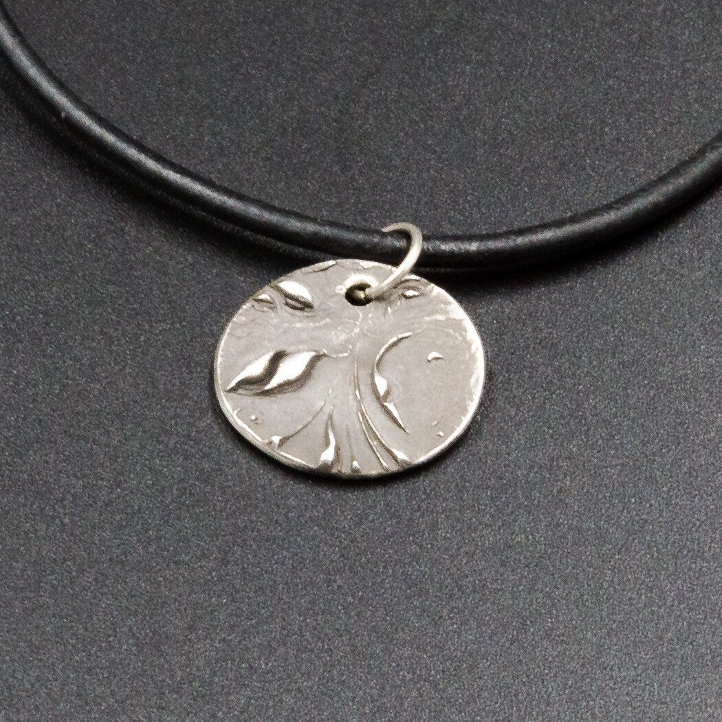 A pure silver pendant stamped with the initial or name of your choice.