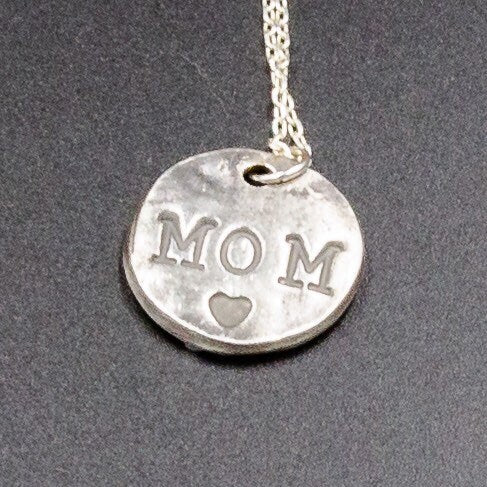 A pure silver pendant stamped with the initial or name of your choice.